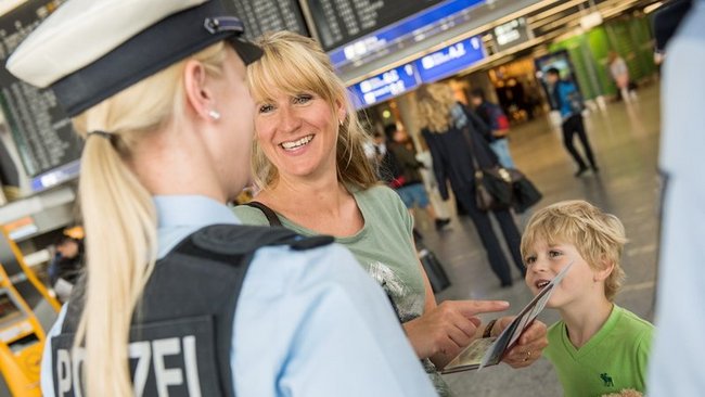 Mutter mit Kind im Gespräch mit Bundespolizei